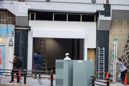 Tokyo, Japan, November 1, 2023: Workers and Pedestrians Near a Renovation Siteのeditorial素材