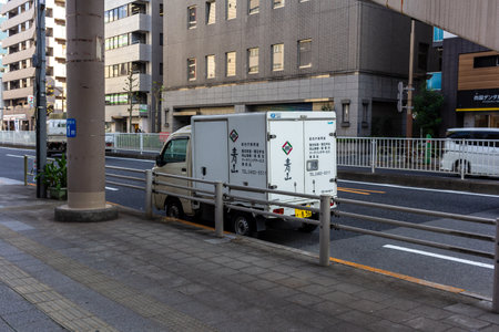 Tokyo, Japan, November 1, 2023: Parked delivery truck with hazard markings on a city streetのeditorial素材