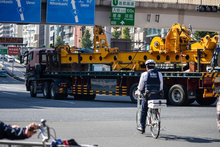 Tokyo, Japan, November 1, 2023: Heavy machinery transportation through Tokyo's busy streetsのeditorial素材