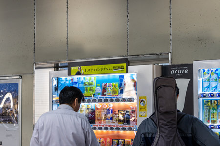 Tokyo, Japan, November 1, 2023: People using vending machines in Tokyoのeditorial素材