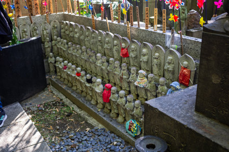 Tokyo, Japan, November 1, 2023: Rows of Jizo Statues in Japanese Temple