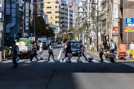 Tokyo, Japan, November 1, 2023: Busy pedestrian crossing in Tokyo's urban areaのeditorial素材