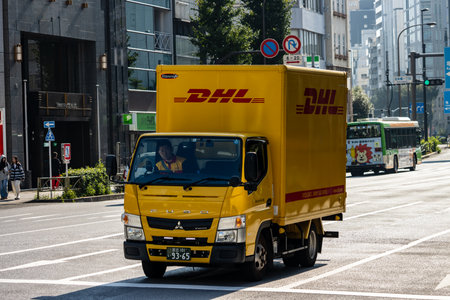 Tokyo, Japan, November 1, 2023: DHL delivery truck navigating through Tokyo trafficのeditorial素材