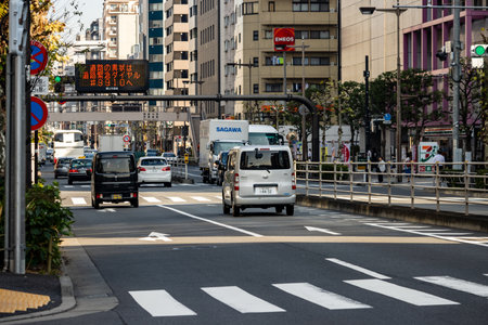 Tokyo, Japan, November 1, 2023: Delivery trucks navigating through the busy streets of Tokyoのeditorial素材