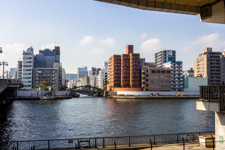 Tokyo, Japan, November 1, 2023: Cityscape with River and Urban Buildingsのeditorial素材