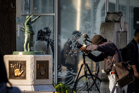 Tokyo, Japan, November 1, 2023: Photographer Capturing a Sculpture in Urban Tokyoのeditorial素材