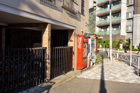 Tokyo, Japan, November 1, 2023: Sidewalk with bicycle parking and a vending machineのeditorial素材