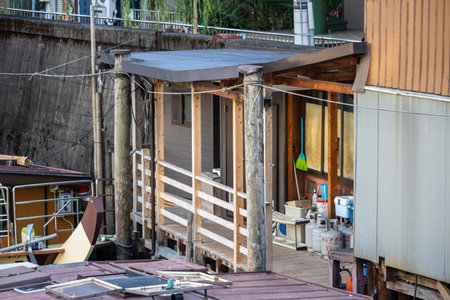 Tokyo, Japan, November 1, 2023: View of a small house and its interior near a canal with personal items visibleのeditorial素材