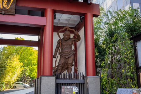 Tokyo, Japan, November 1, 2023: Carved Guardian Deity at the Entrance of a Shrineのeditorial素材
