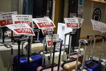 Tokyo, Japan, November 1, 2023: Luggage sale with discounted prices on the sidewalkのeditorial素材