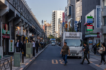 Tokyo, Japan, November 1, 2023: Busy Street Scene with Pedestrians and Delivery Trucksのeditorial素材