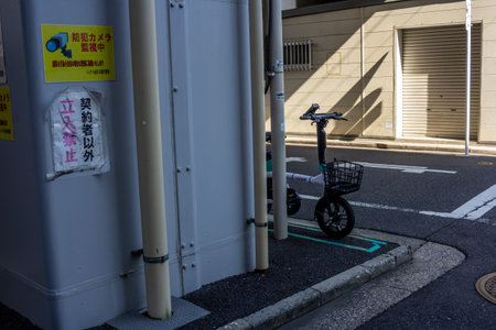 Tokyo, Japan, November 1, 2023: Electric Scooter Parked by the Side of the Roadのeditorial素材