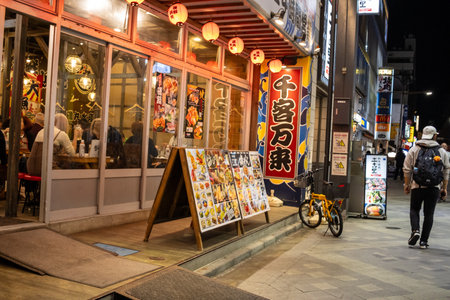 Tokyo, Japan, November 1, 2023: Bustling Izakaya Restaurant with Customers and Lanterns at Nightのeditorial素材
