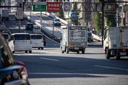 Tokyo, Japan, November 1, 2023: Traffic on a busy Tokyo street with directional signs to the toll roadのeditorial素材