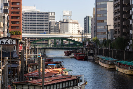 Tokyo, Japan, November 1, 2023: Scenic View of Boats Docked Along the Kanda River with Cityscapeのeditorial素材