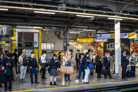 Tokyo, Japan, November 1, 2023: Commuters waiting for train at busy station platformのeditorial素材