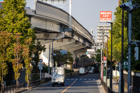 Tokyo, Japan, November 1, 2023: Street view under an overpass in Tokyo with cars and pedestriansのeditorial素材