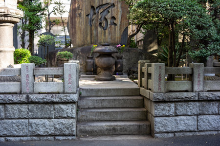Tokyo, Japan, November 1, 2023: Traditional stone monument and water basin at a Japanese templeのeditorial素材