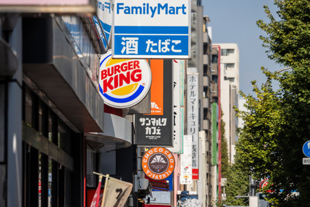 Tokyo, Japan, November 1, 2023: Commercial street with FamilyMart and Burger King signs among other businessesのeditorial素材