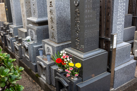 Tokyo, Japan, November 1, 2023: Traditional Japanese Grave with Flowers and Incense Sticksのeditorial素材