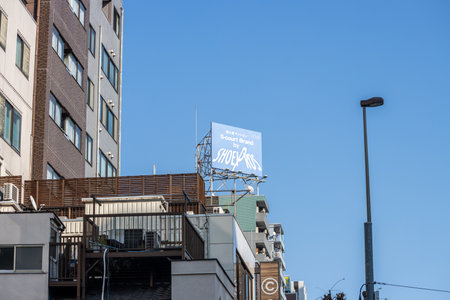 Tokyo, Japan, November 1, 2023: Prominent billboard advertising Shoei helmets atop a building in a clear blue skyのeditorial素材