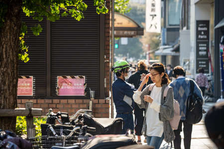 Tokyo, Japan, November 1, 2023: Pedestrians and a security guard in busy streetのeditorial素材