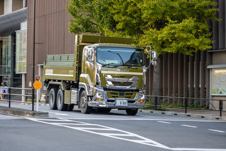 Tokyo, Japan, November 1, 2023: Isuzu dump truck driving on the street in urban areaのeditorial素材