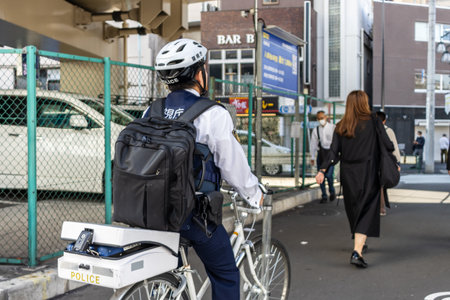 Tokyo, Japan, November 2, 2023: Police officer on bicycle patrolling the streets of Chuoのeditorial素材