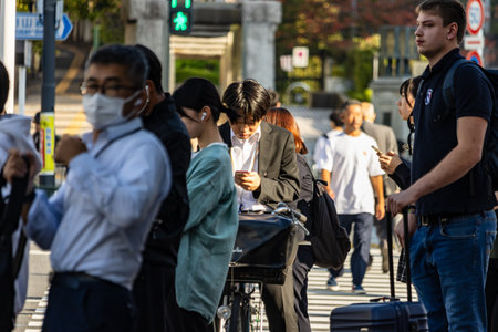 Tokyo, Japan, November 2, 2023: Bustling Shibuya Crossing with Diverse Crowd of Pedestrians Wearing Masksのeditorial素材