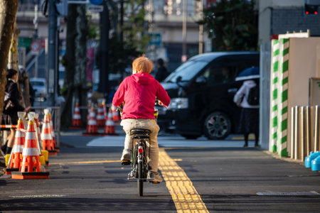 Tokyo, Japan, November 2, 2023: Cyclist riding on a designated bike lane in the cityのeditorial素材