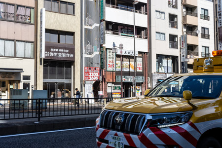 Tokyo, Japan, November 2, 2023: Colorful taxi on Tokyo street with advertising signs and pedestriansのeditorial素材