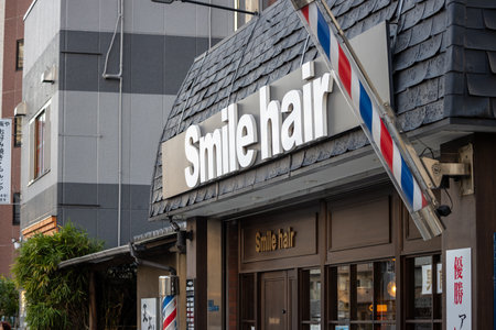 Tokyo, Japan, November 2, 2023: Exterior of a Smile Hair Salon with Barber's Poleのeditorial素材