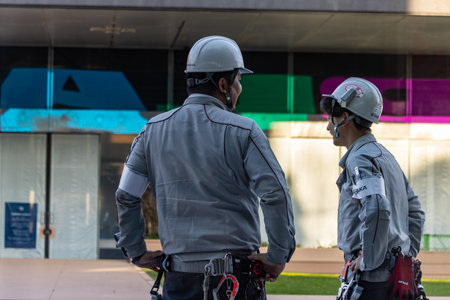 Tokyo, Japan, November 2, 2023: Security personnel monitoring area in front of contemporary building...