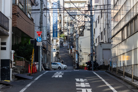 Tokyo, Japan, November 2, 2023: Urban scene with power lines and road markings in Tokyo's backstreetのeditorial素材