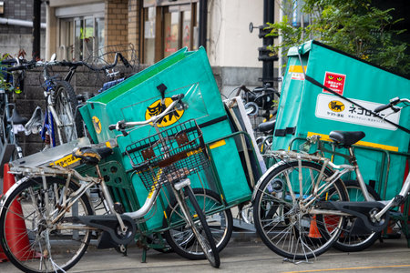 Tokyo, Japan, November 2, 2023: Delivery bicycles with green cargo boxes parked on the streetのeditorial素材