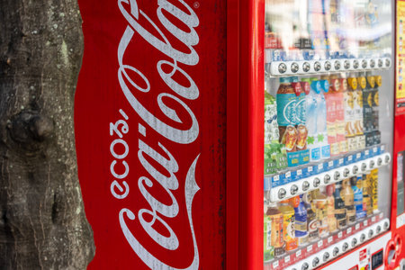 Tokyo, Japan, November 2, 2023: Close-up of a Coca-Cola vending machine next to a Gachapon toy capsule vending machine alleyのeditorial素材
