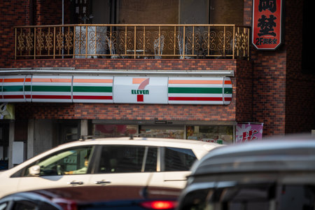 Tokyo, Japan, November 2, 2023: 7-Eleven store sign viewed from a busy streetのeditorial素材
