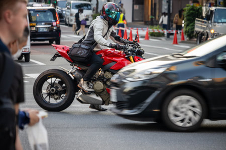 Tokyo, Japan, November 2, 2023: Traffic scene with motorcyclist and cars in motion blurのeditorial素材