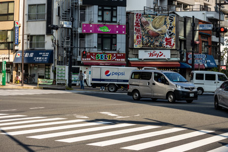 Tokyo, Japan, November 1, 2023: Busy Street Scene with Cars and Colorful Signage in Asakusaのeditorial素材