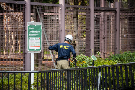 Tokyo, Japan, October 31, 2023: Construction worker inspecting a site near a fenced areaのeditorial素材