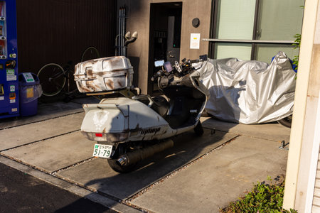 Tokyo, Japan, November 2, 2023: Delivery scooters parked outside a buildingのeditorial素材