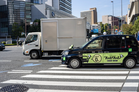 Tokyo, Japan, November 2, 2023: Taxi and delivery truck at a busy intersectionのeditorial素材