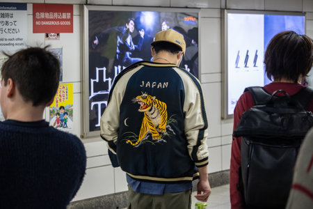 Tokyo, Japan, November 2, 2023: Pedestrians Walking by an Advertisement in a Subway Stationのeditorial素材