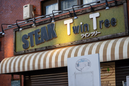 Tokyo, Japan, November 2, 2023: Weathered sign of the Steak Twin Tree restaurantのeditorial素材