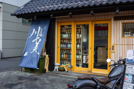 Tokyo, Japan, November 2, 2023: Traditional Japanese sake shop with blue noren curtainのeditorial素材