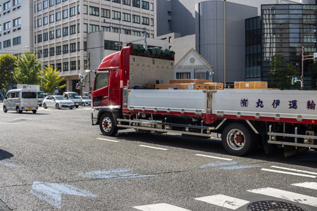 Tokyo, Japan, November 2, 2023: Red delivery truck transporting goods in the cityのeditorial素材