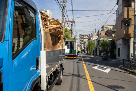 Tokyo, Japan, November 2, 2023: Blue Delivery Truck Loaded with Wood on Urban Streetのeditorial素材