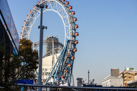 Tokyo, Japan, November 2, 2023: Ferris wheel in urban setting with clear blue skyのeditorial素材