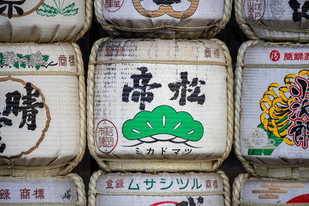 Tokyo, Japan, November 3, 2023: Close-up of stacked sake barrels with traditional markingsのeditorial素材