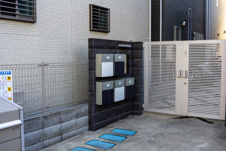 Tokyo, Japan, November 3, 2023: Modern Public Mailboxes on a Sidewalk